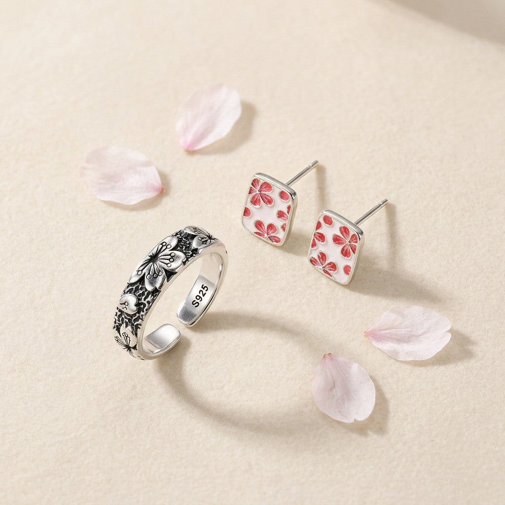 The Hanami Set — Sakura Ring Komorebi and The Sakura Essence Studs on an ivory backdrop