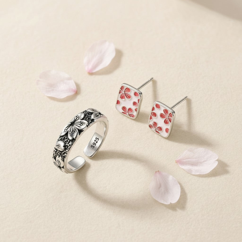 The Hanami Set — Sakura Ring Komorebi and The Sakura Essence Studs, wide banner view with cherry blossom petals