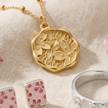The Kanzashi Trio — macro close-up of the gold pendant, stud earrings and engraved ring