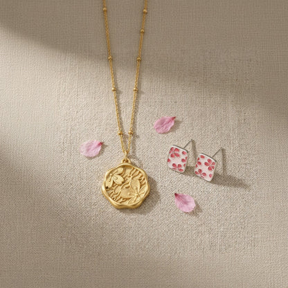 The Mono no Aware — wide view of the gold pendant necklace chain and cherry blossom studs