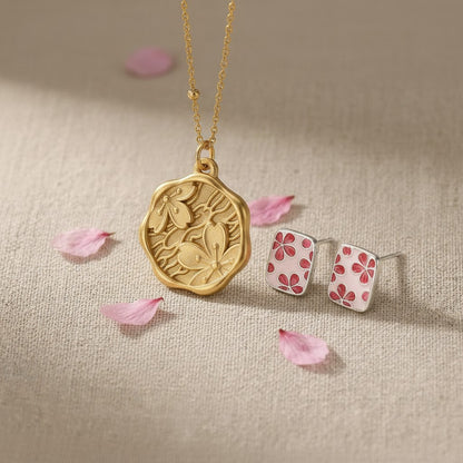 The Mono no Aware — close-up of the engraved gold pendant and cherry blossom stud earring